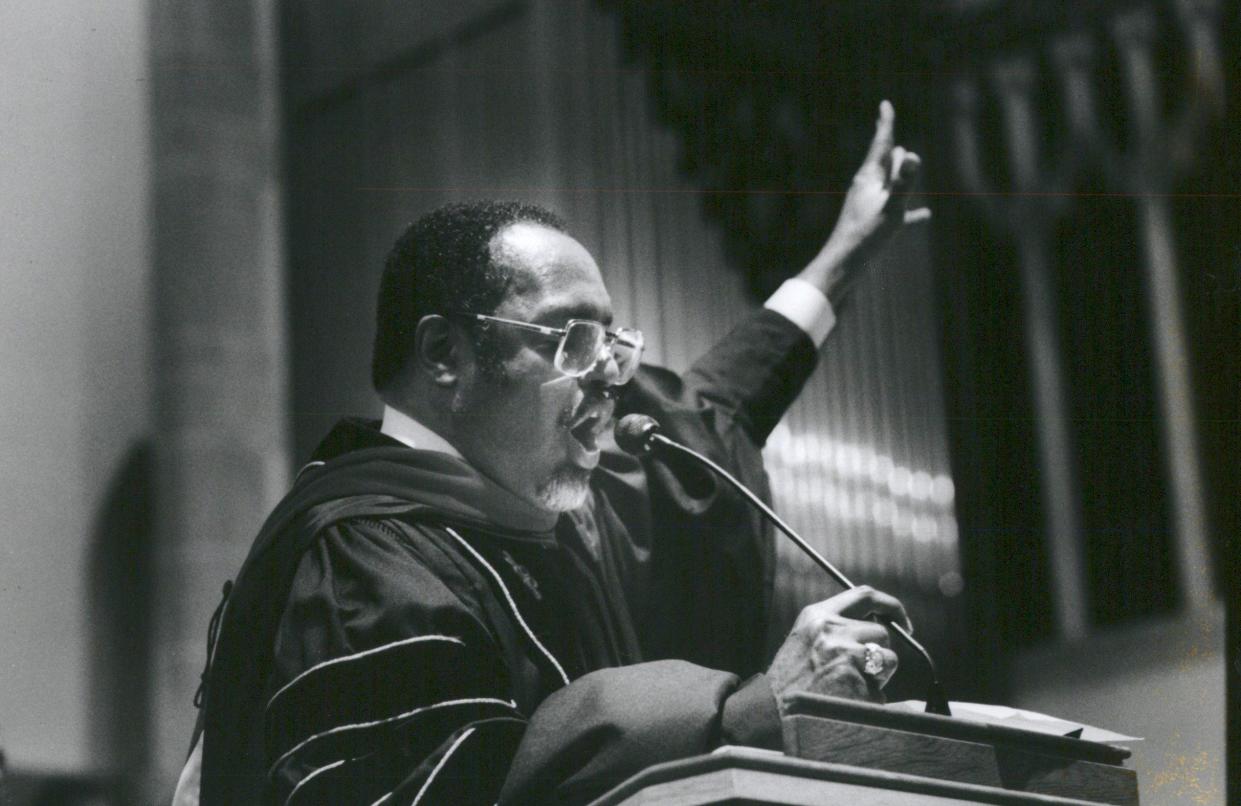 Rev. Charles G. Adams of Hartford Memorial Baptist Church in Detroit raises his hand during a reading of scriptures.