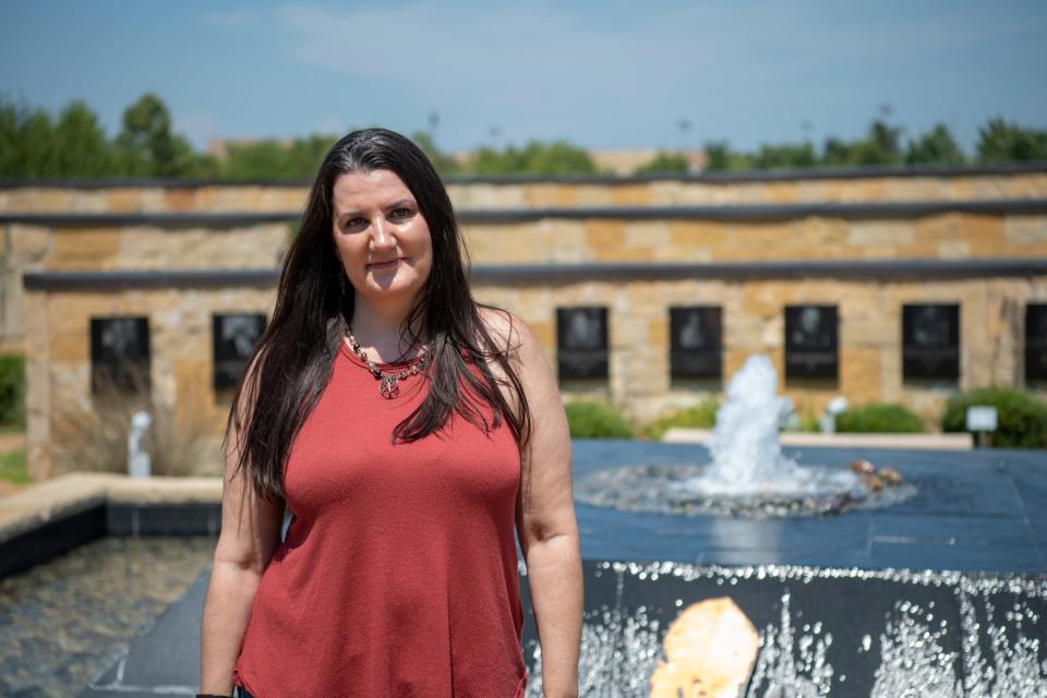 Shelby Rowe stands in the Aaholiitobli' Honor Garden at the Chickasaw Cultural Center in Sulphur, Oklahoma. Surrounding her are plaques honoring Chickasaw leaders, elders and warriors.

Rowe has reconnected with her Chickasaw roots as part of her healing process.