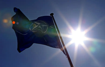 FILE PHOTO - A NATO flag flies at the Alliance's headquarters in Brussels, March 2, 2014. REUTERS/Yves Herman/File Photo