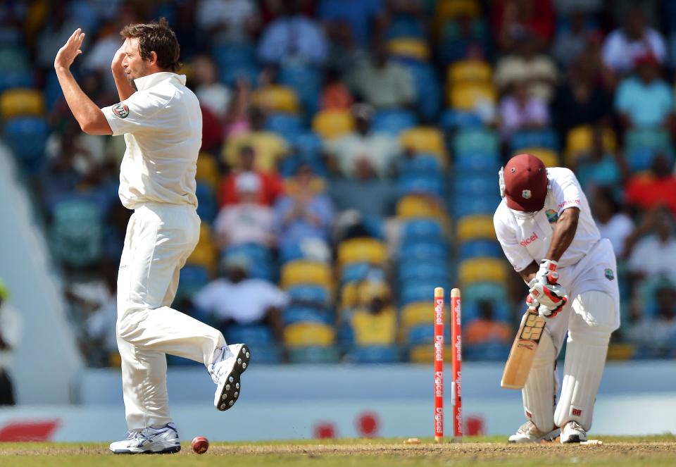 Australian cricketer Ben Hilfenhaus (L) celebrates after bowling out West Indies batsman Adrian Barath (R) during the fourth day of the first-of-three Test matches between Australia and West Indies at the Kensington Oval stadium in Bridgetown on April 10, 2012. Australia trailed by 43 runs at the end of the first innings. AFP PHOTO/Jewel Samad (Photo credit should read JEWEL SAMAD/AFP/Getty Images)