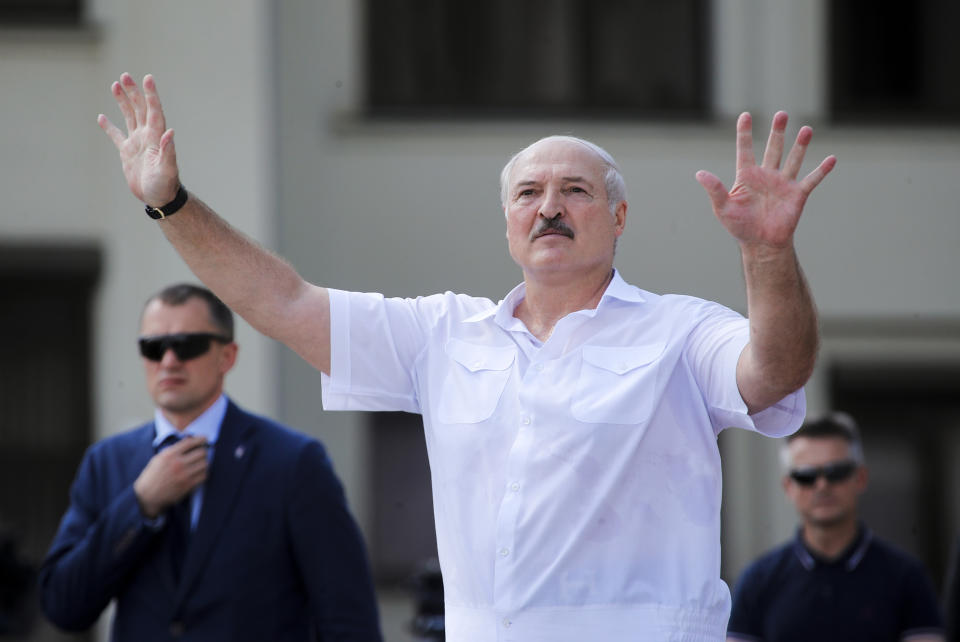 FILE - In this Aug. 16, 2020, file photo, Belarusian President Alexander Lukashenko gestures as he greets supporters at Independence Square in Minsk, Belarus. With protests in Belarus now in their third week, Lukashenko is moving to squelch the demonstrations gradually with vague promises of reforms mixed with threats, court summonses and the selective jailing of leading activists. (AP Photo/Dmitri Lovetsky, File)