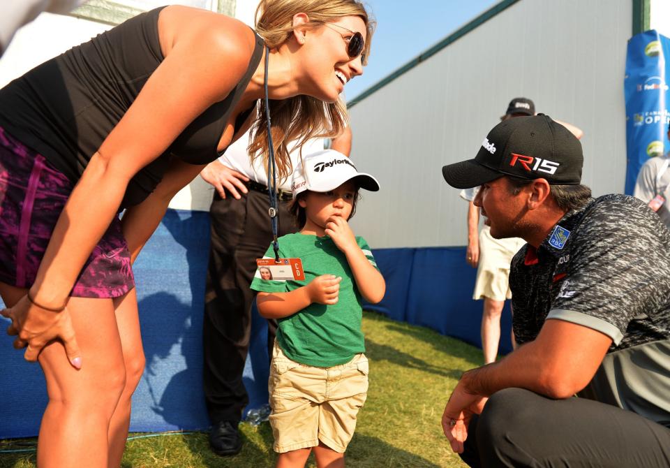 <p>Jason Day of Australia talks to his son Dash and wife Ellie after finishing round three of the RBC Canadian Open at Glen Abbey Golf Club on July 25, 2015 in Oakville, Canada. (Photo by Minas Panagiotakis/Getty Images) </p>