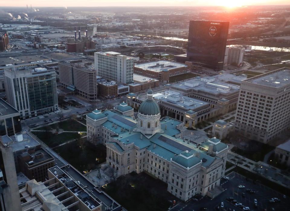 Sunsets behind the Indiana Statehouse in downtown Indianapolis, Wednesday, Dec. 2, 2020.