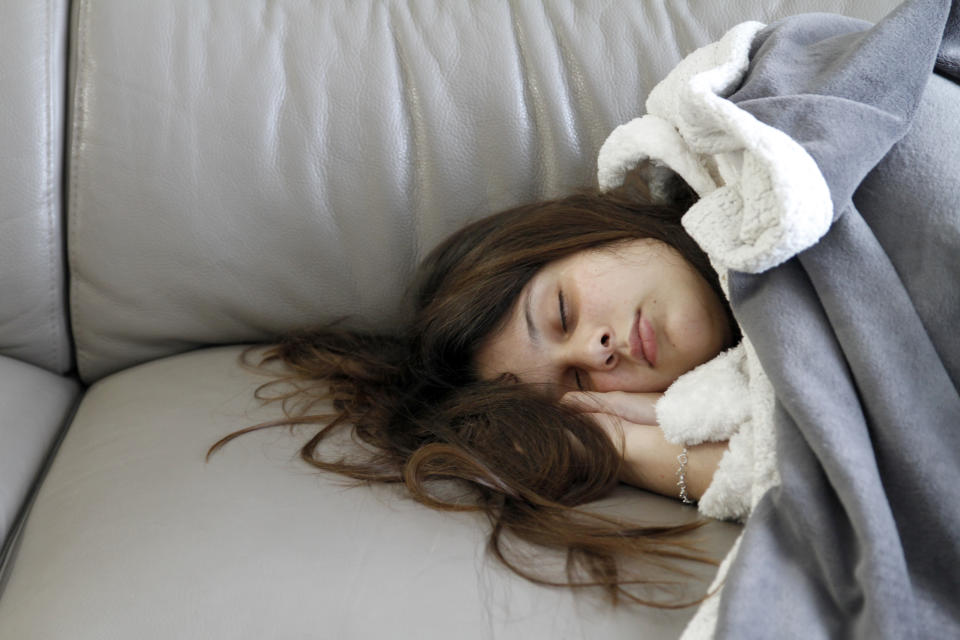 Sick woman sleeping on sofa