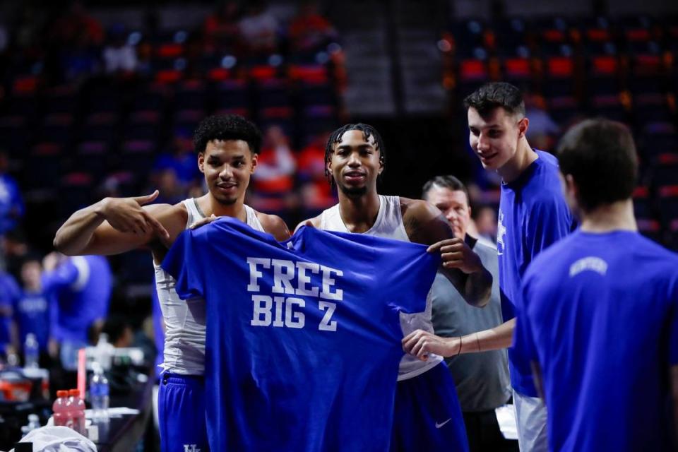 Prior to a game at Florida on Jan. 6., Kentucky basketball players Tre Mitchell, left, and Jordan Burks pose with a shirt calling for teammate Zvonimir Ivisic, right, to be ruled eligible by the NCAA.