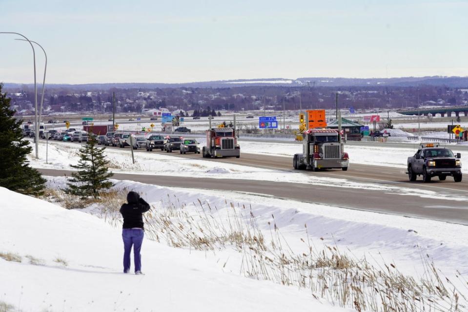 Truck drivers protesting against coronavirus disease (COVID-19) vaccine mandates drive in a convoy on the Nova Scotia/New Brunswick provincial boundary in Fort Lawrence, Nova Scotia, Canada, January 23 (REUTERS)