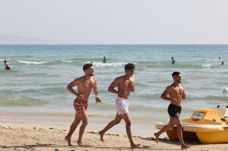 People spend the day on the beach in the port city of Tyre in southern Lebanon despite fears of war with Israel amid near-daily clashes between Hezbollah and Israeli forces (ANWAR AMRO)