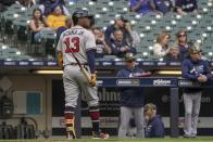 Atlanta Braves' Ronald Acuna Jr. walks back to the dugout after striking out during the eighth inning of a baseball game against the Milwaukee Brewers Sunday, May 16, 2021, in Milwaukee. (AP Photo/Morry Gash)