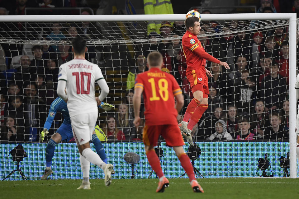 Aaron Ramsey, top right, of Wales scores the opening goal against Hungary, during the Euro 2020 group E qualifying soccer match between Wales and Hungary at Cardiff City Stadium in Cardiff, Wales, Tuesday, Nov. 19, 2019. (Tamas Kovacs/MTI via AP)