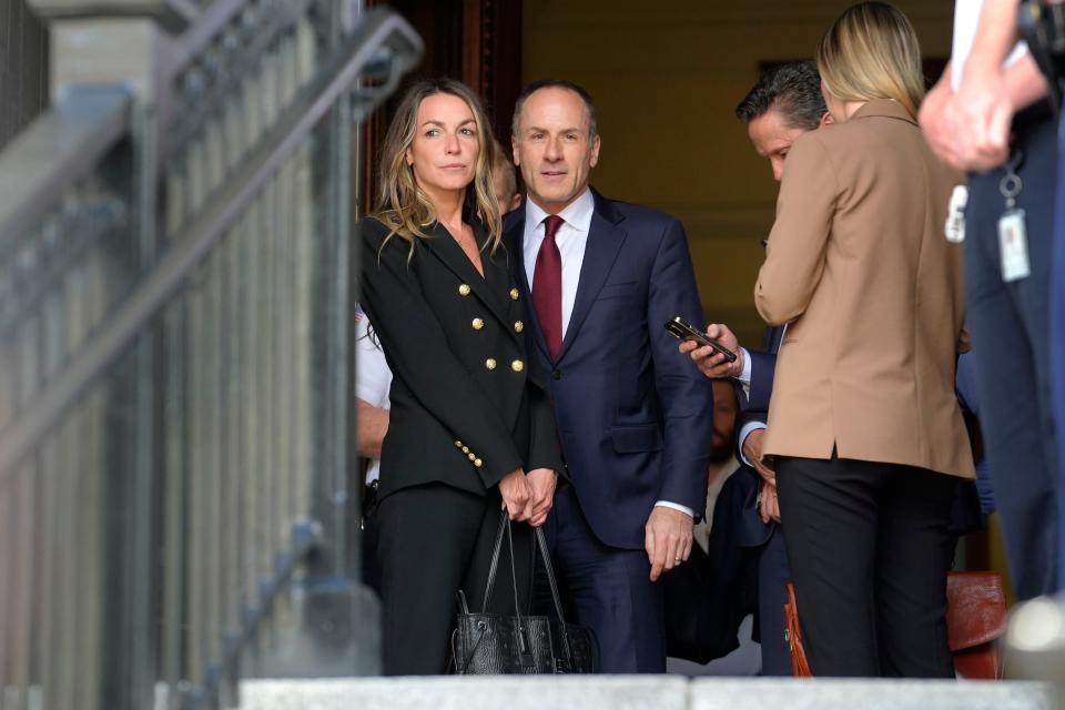 Karen Read, left, stands in a doorway near defense attorney David Yannetti, center, as they depart Norfolk Superior Court, Thursday, June 27, 2024, in Dedham, Mass. Read is on trial, accused of killing her boyfriend Boston police Officer John O'Keefe, in 2022. The jury began deliberations in the trial Tuesday. (AP Photo/Steven Senne)