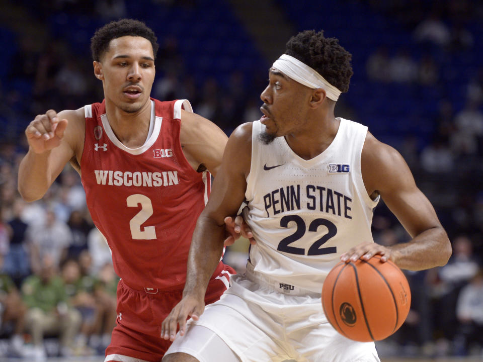 Penn State's Jalen Pickett (22) looks to pass around Wisconsin's Jordan Davis (2) during the first half of an NCAA college basketball game, Wednesday, Feb. 8, 2023, in State College, Pa. (AP Photo/Gary M. Baranec)