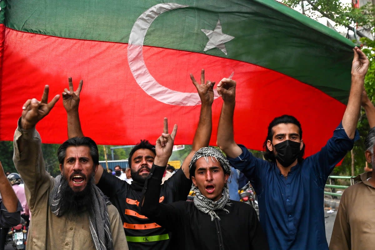 Pakistan Tehreek-e-Insaf party activists and supporters of Imran Khan celebrate in Lahore after the supreme court declared his arrest invalid. He has since been jailed (Arif Ali / AFP via Getty Images)