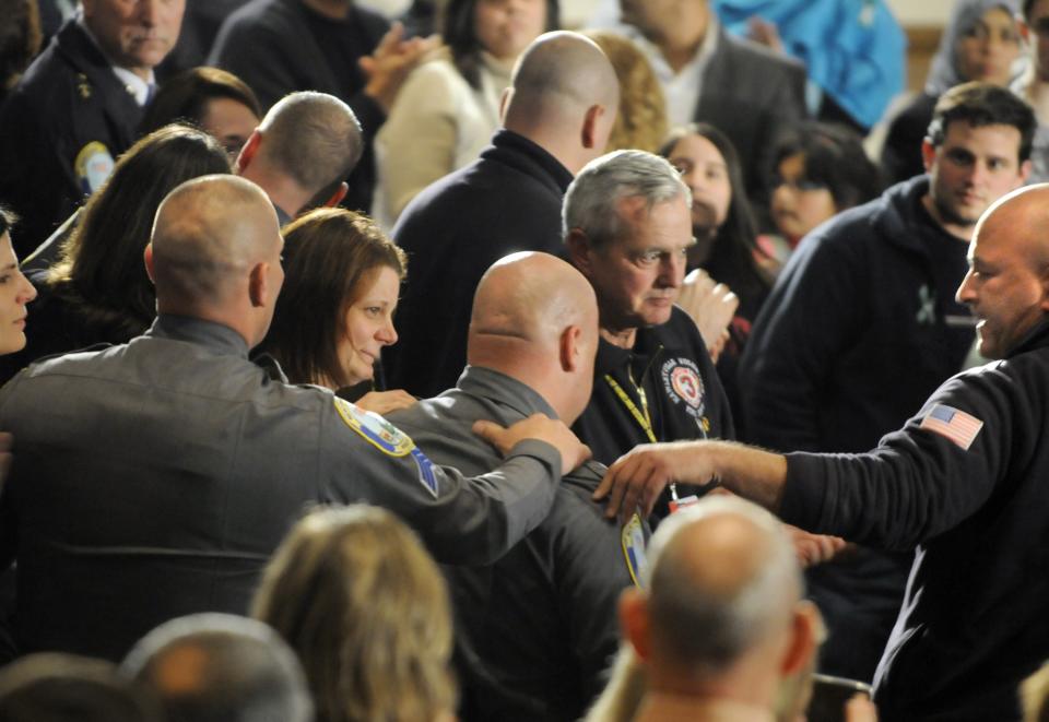 NEWTOWN, CT - DECEMBER 16: Newtown first responders received an emotional standing ovation as they entered the auditorium for a vigil at Newtown High School on December 16, 2012 at Newtown High School in Newtown, Connecticut. Twenty-six people were shot dead, including twenty children, after a gunman identified as Adam Lanza opened fire at Sandy Hook Elementary School. Lanza also reportedly had committed suicide at the scene. A 28th person, believed to be Nancy Lanza, found dead in a house in town, was also believed to have been shot by Adam Lanza. (Photo by Stephen Dunn-Pool/Getty Images)
