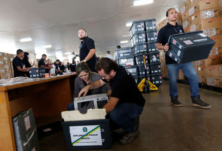 Brazilian electoral workers seal electronic ballot boxes in Brasilia, Brazil September 19, 2018. REUTERS/Adriano Machado