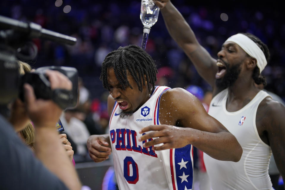 Philadelphia 76ers' Tyrese Maxey, center, is doused by Patrick Beverley after an NBA basketball game against the Indiana Pacers, Sunday, Nov. 12, 2023, in Philadelphia. (AP Photo/Matt Slocum)