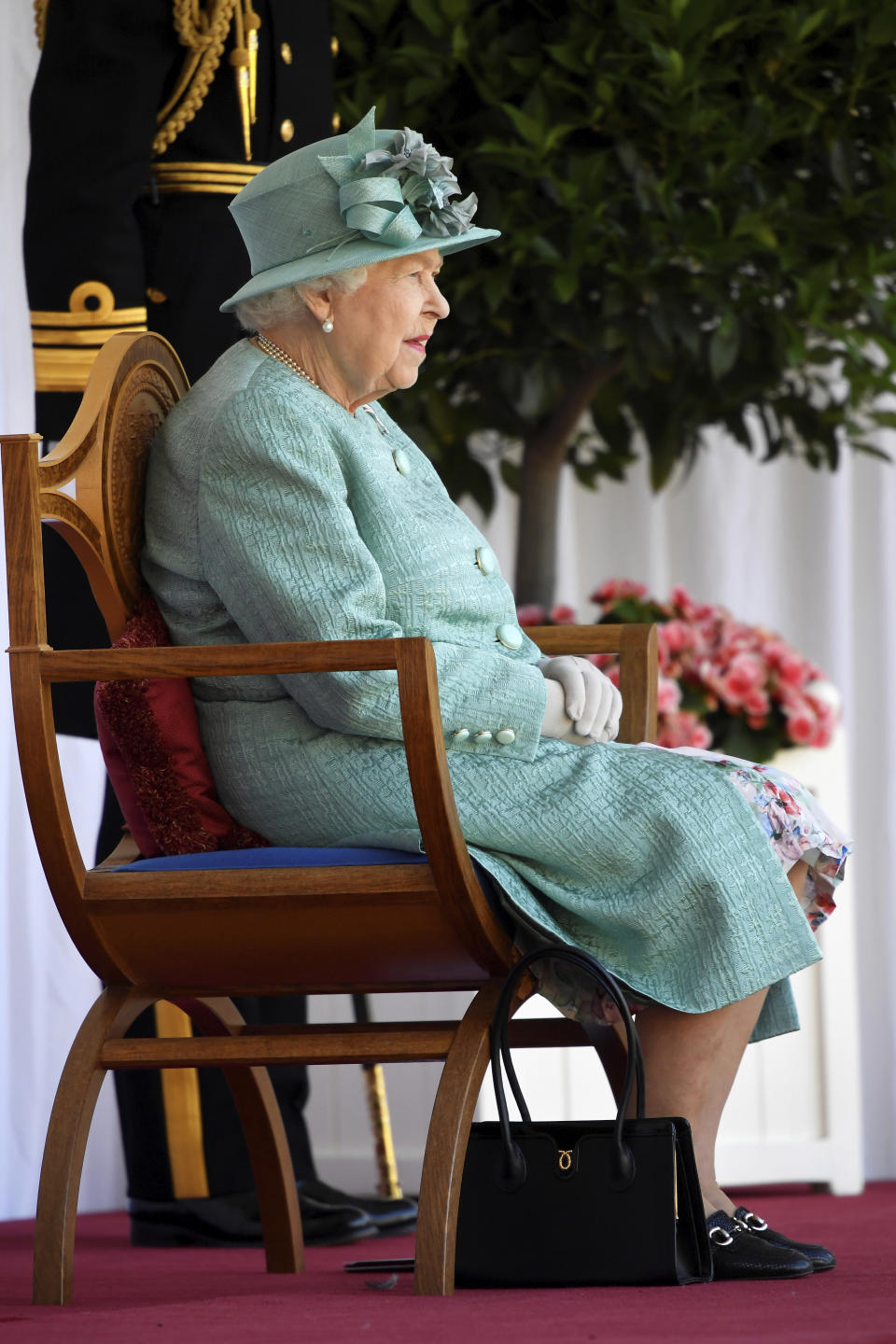 Britain's Queen Elizabeth II attends a ceremony to mark her official birthday at Windsor Castle in Windsor, England, Saturday June 13, 2020. Queen Elizabeth II’s birthday is being marked with a smaller ceremony than usual this year, as the annual Trooping the Color parade is canceled amid the coronavirus pandemic. The Queen celebrates her 94th birthday this year. (Toby Melville/Pool via AP)