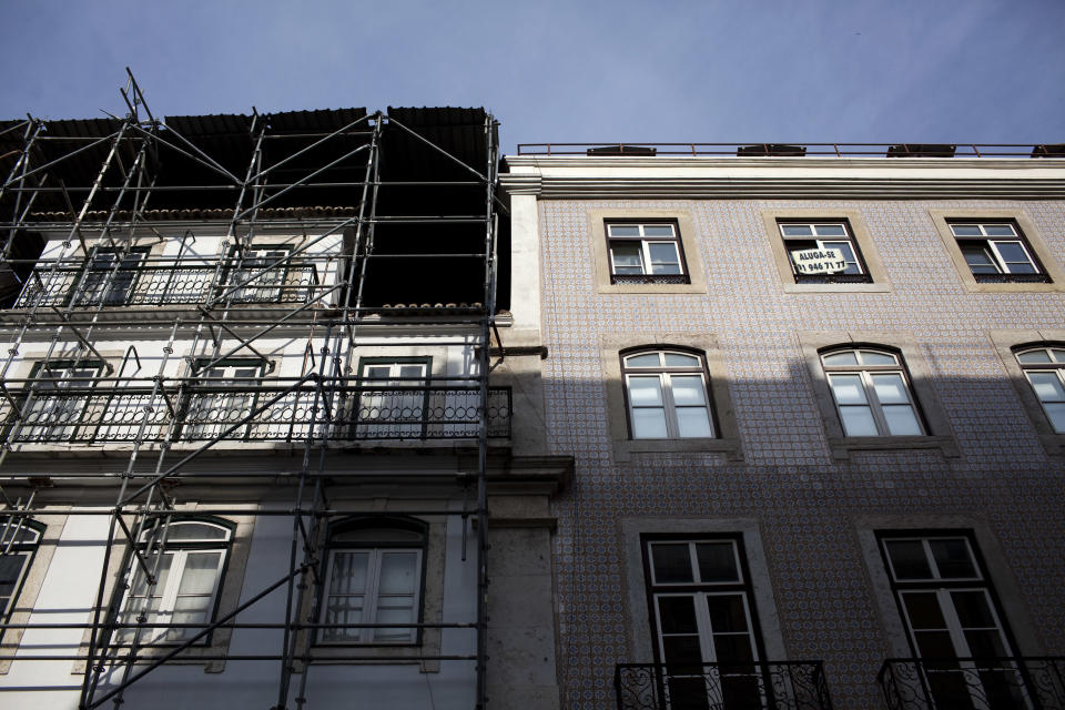 In this Sept. 28, 2012 photo, a sign on the window of an apartment building announces "for rent", next to another building being renovated, in downtown Lisbon. Portugal is scrapping its long-standing rent controls in one of the government's most radical economic and social reforms since the ailing country needed a euro 78 billion bailout last year, when it was engulfed by Europe's financial crisis. Critics say the anticipated rent hikes from next month could price thousands of families out of their homes. At the very least, the change aimed at boosting and modernizing the economy, will add to the financial burden on those struggling to cope with pay cuts and tax hikes designed to ease the country's crippling debt load. (AP Photo/Armando Franca)