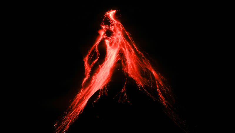 Mayon volcano spews lava as seen from Legaspi, Albay province, northeastern Philippines, Sunday, June 11, 2023. More than 13,000 people have been evacuated from the area.