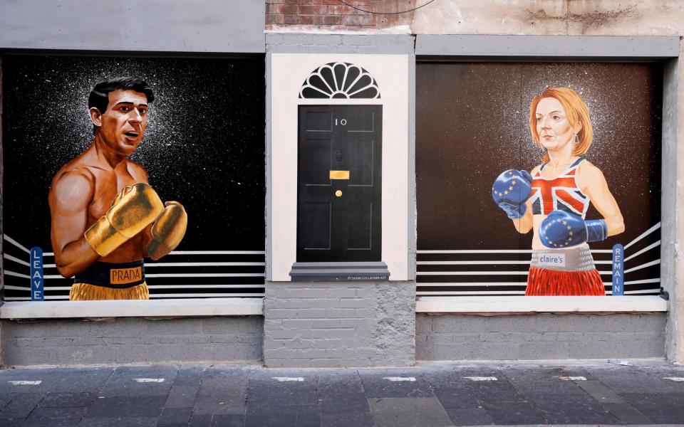 Clash of the Titans: A new mural depicting Rishi Sunak and Liz Truss as boxers appears on a wall in Belfast - AP Photo/Peter Morrison