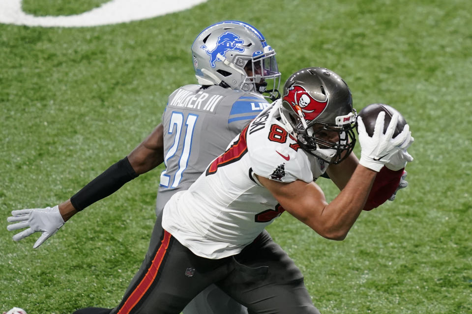 Tampa Bay Buccaneers tight end Rob Gronkowski (87), defended by Detroit Lions defensive back Tracy Walker (21), catches a 33-yard pass for a touchdown during the first half of an NFL football game, Saturday, Dec. 26, 2020, in Detroit. (AP Photo/Carlos Osorio)