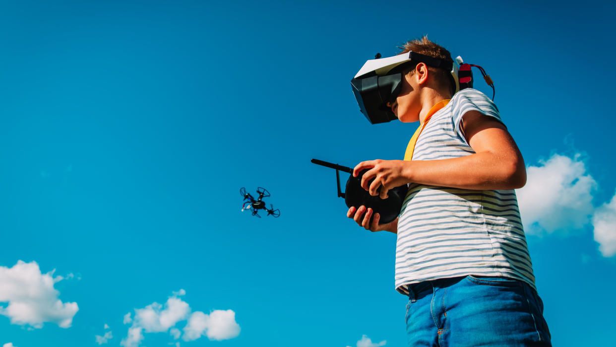  Best beginner drone: Image shows you boy flying a drone with FPV goggles 