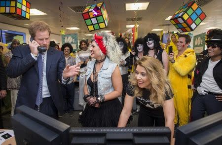 Britain's Prince Harry takes part in a charity trading day at ICAP with Kate Arnold and Samantha Bennett on the EBS Direct Desk in support of his charity Sentebale, in London, December 7, 2016. REUTERS/Geoff Pugh/Pool