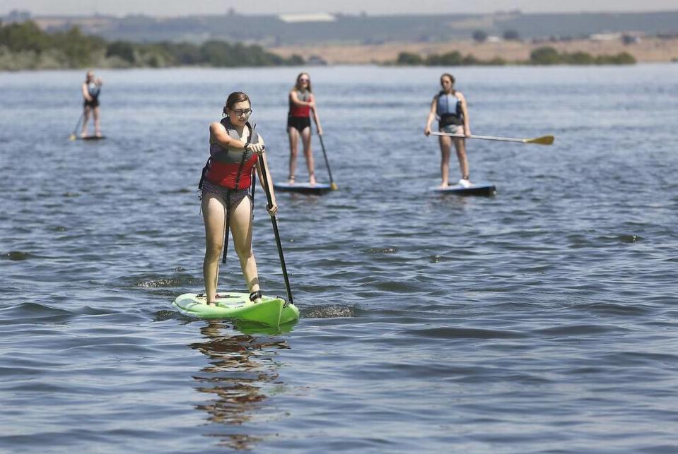 Paddleboarders make their way down the Columbia River.