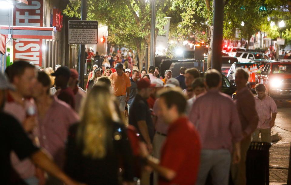 Pedestrian and vehicular traffic move along University Boulevard on the Strip following the Alabama game with Tennessee Saturday, October 21, 2017. [Staff Photo/Gary Cosby Jr.]