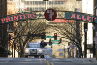 A police officer blocks a street as the investigation continues into an explosion Saturday, Dec. 26, 2020, in Nashville, Tenn. An explosion that shook the largely deserted streets of downtown Nashville early Christmas morning shattered windows, damaged buildings, and wounded three people. Authorities said they believed the blast was intentional. (AP Photo/Mark Humphrey)