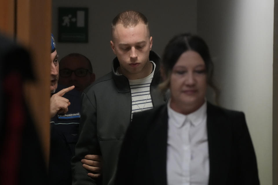 Finnegan Lee Elder is escorted into the courtroom for the appeal trial for the killing of Italian policeman Mario Cerciello Rega, in Rome, Friday, March. 8, 2024. The two American men face a new trial in the slaying of an Italian plainclothes police officer during a botched sting operation after Italy's highest court threw out their convictions. (AP Photo/Gregorio Borgia)