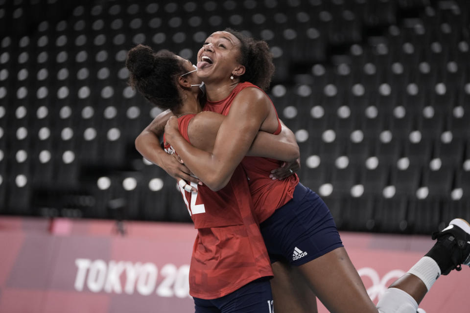 Jordan Thompson, left, and Haleigh Washington, of the United States, embrace after their 3-2 victory over Turkey, at the end of a women's volleyball preliminary round pool B match, at the 2020 Summer Olympics, early Friday, July 30, 2021, in Tokyo, Japan. (AP Photo/Manu Fernandez)