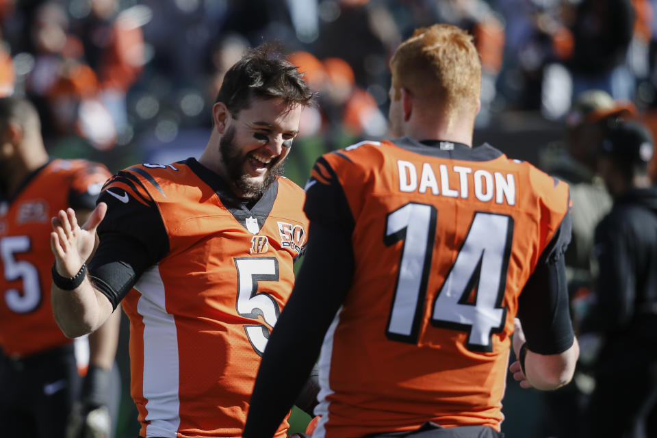 Cincinnati Bengals quarterback AJ McCarron (5), wih quarterback Andy Dalton (14), can become a free agent after winning a grievance. (AP)