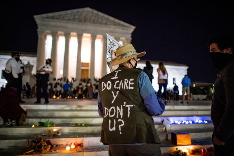 People gather outside of the U.S. Supreme Court following the death of U.S. Supreme Court Justice Ruth Bader Ginsburg, in Washington