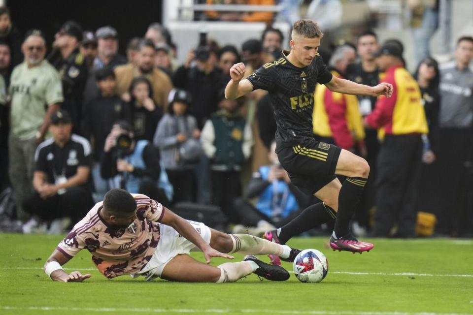 Portland Timbers defender Zac McGraw, left, tackles LAFC forward Stipe Biuk during the second half Saturday.