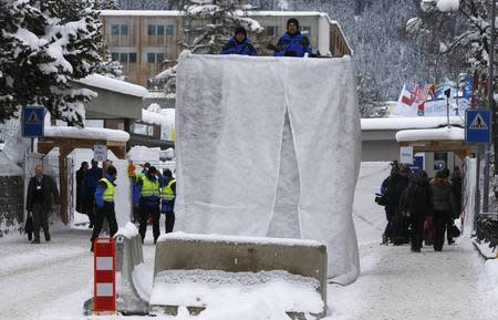 Swiss police officers control the area at the Davos Congress Centre during the Annual Meeting 2016 of the World Economic Forum (WEF) in Davos, Switzerland January 20, 2016. REUTERS/Ruben Sprich