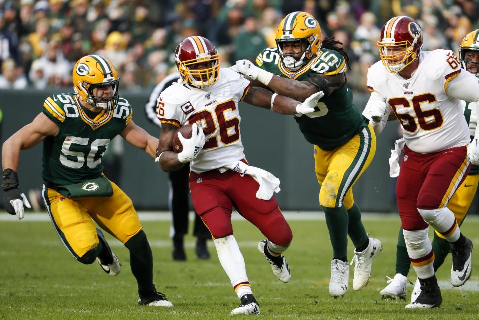 Washington Redskins' Adrian Peterson runs during the first half of an NFL football game against the Green Bay Packers Sunday, Dec. 8, 2019, in Green Bay, Wis. (AP Photo/Matt Ludtke)