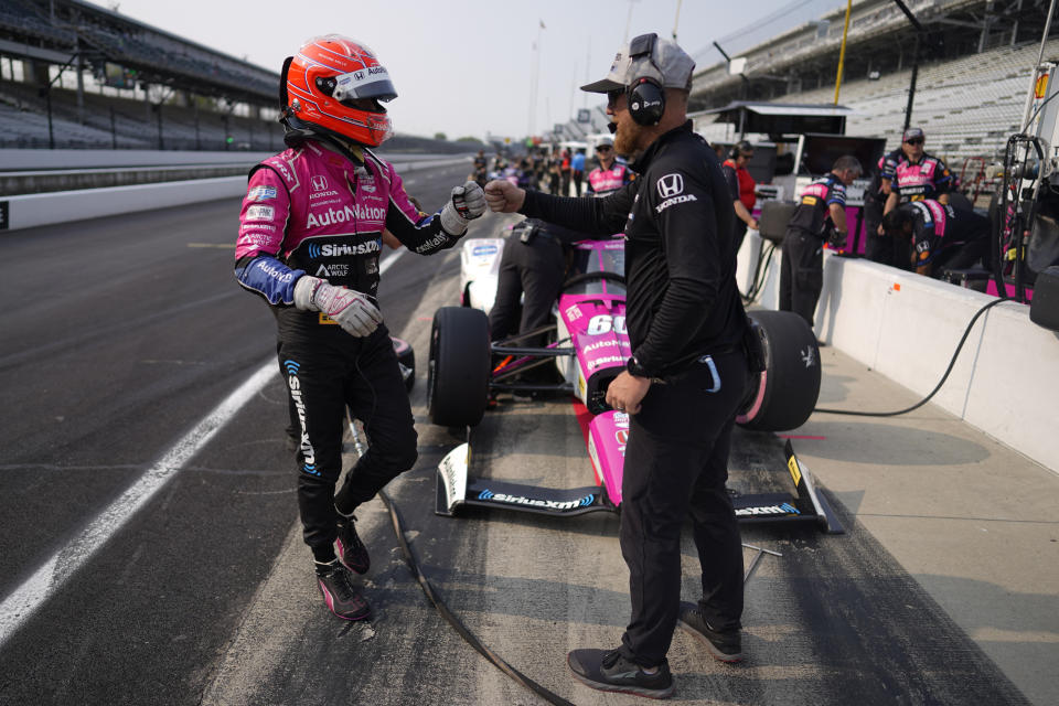 Simon Pagenaud, of France, greets a team member during practice for the Indianapolis 500 auto race at Indianapolis Motor Speedway, Thursday, May 18, 2023, in Indianapolis. (AP Photo/Darron Cummings)