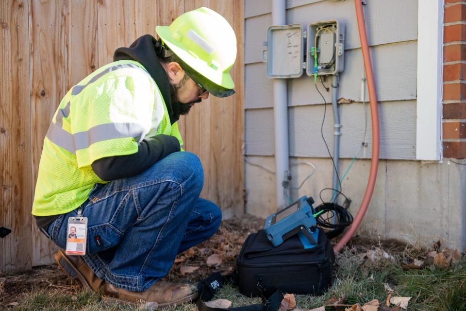 Fort Collins Connexion Technician Scott Lopez repairs a network interface device at a Fort Collins residence in this file photo.