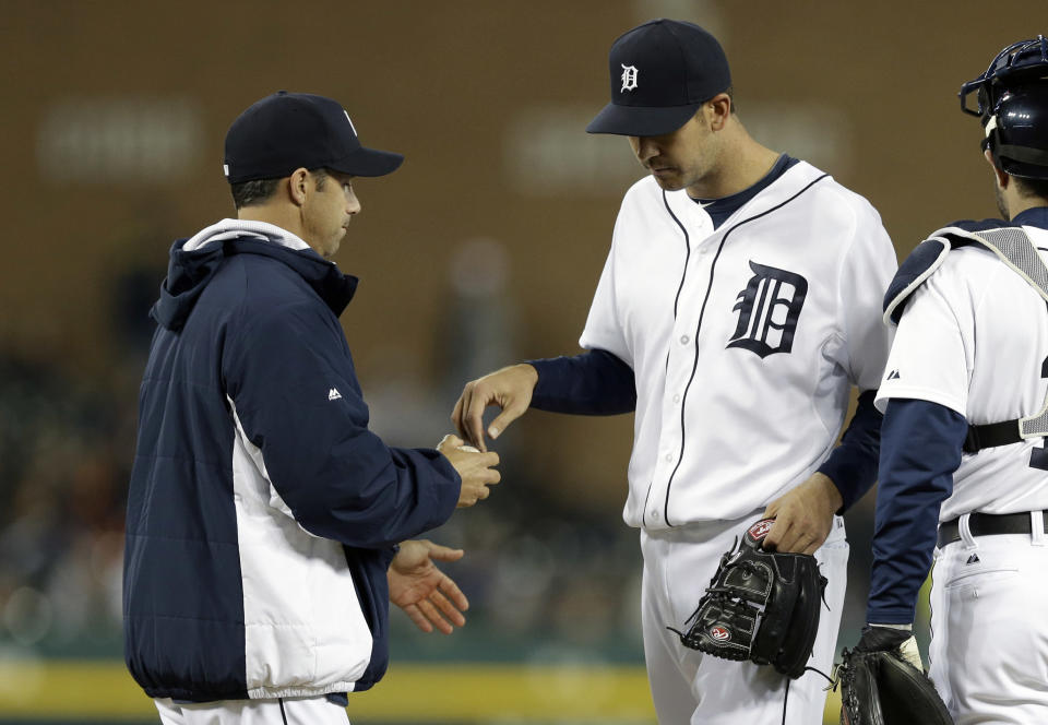 Detroit Tigers manager Brad Ausmus, left, relieves pitcher Luke Putkonen during the sixth inning of a baseball game against the Los Angeles Angels in Detroit, Friday, April 18, 2014. (AP Photo/Carlos Osorio)