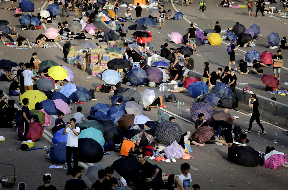 Student activists sleep on a road, many under the shade of umbrellas, near the government headquarters where pro-democracy activists have gathered and made camp, Tuesday, Sept. 30, 2014, in Hong Kong.  (AP Photo/Wong Maye-E)