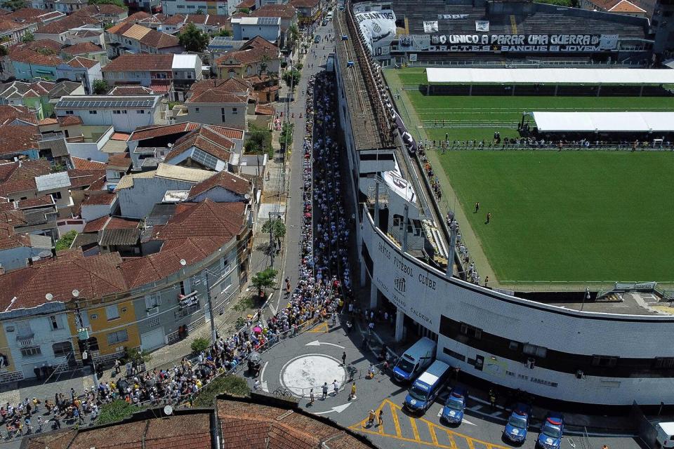 Fans of Brazilian soccer legend Pele gather outside Urbano Caldera stadium to watch his wake in Santos, Sao Paulo, Brazil