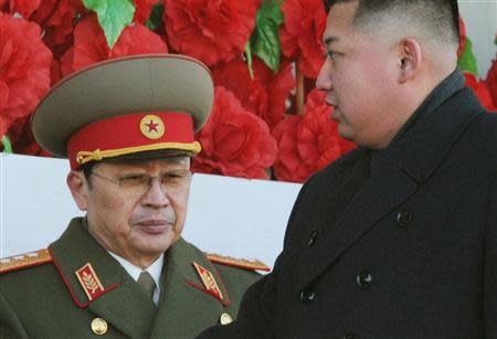 North Korean leader Kim Jong-un (R), walks past his uncle North Korean politician Jang Song-thaek, during a military parade to mark the birth anniversary of the late leader, Kim Jong-il in Pyongyang, in this file photo taken by Kyodo February 16, 2012. REUTERS/Kyodo/File