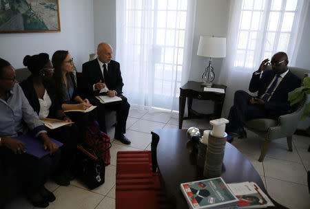 Oxfam International Regional Director for Latin America, Simon Ticehurst, and Oxfam Intermon Executive Affiliate Unit head, Margalida Massot, speak with Haiti's Minister of Planning and External Cooperation Aviol Fleurant at their arrival for a meeting in Port-au-Prince, Haiti, February 19, 2018. REUTERS/Andres Martinez Casares