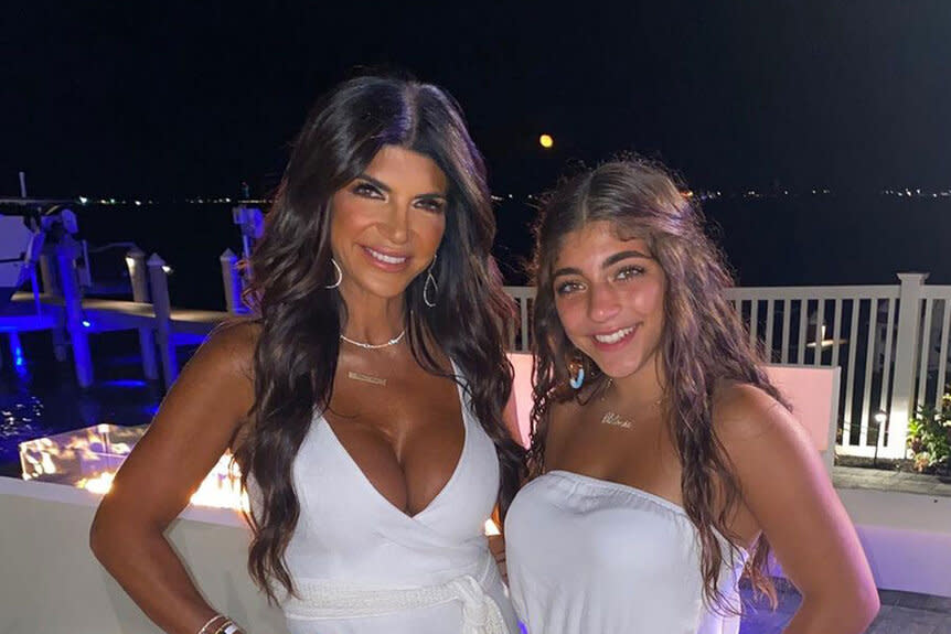 Teresa Giudice and Milania Giudice pose together wearing white dresses.