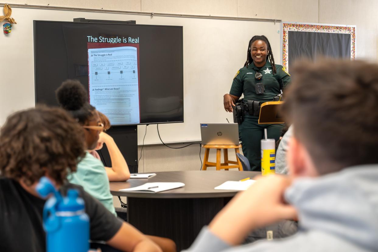 Lake County Sheriff's Deputy Monique Barnes instructs a LEAD lesson at Tavares High School.