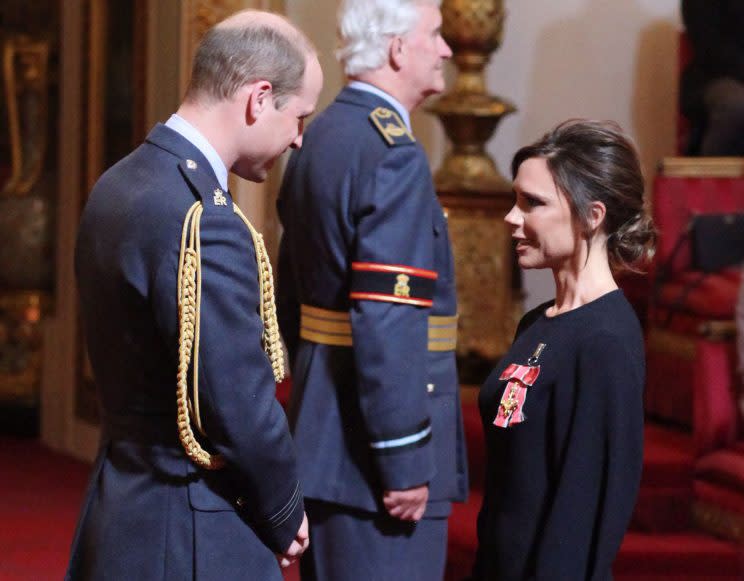 Victoria Beckham was all smiles while receiving her OBE from Prince William