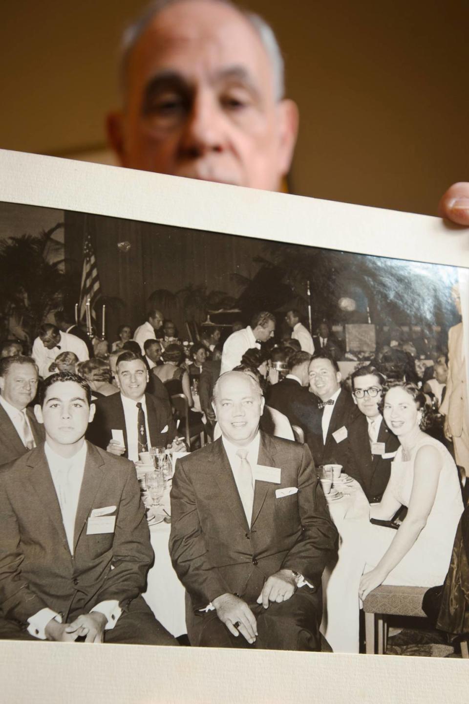 Richard DiMare holds the last picture taken of his father, center, with a young Richard at his side,  on Tuesday, March 15, 2011. 