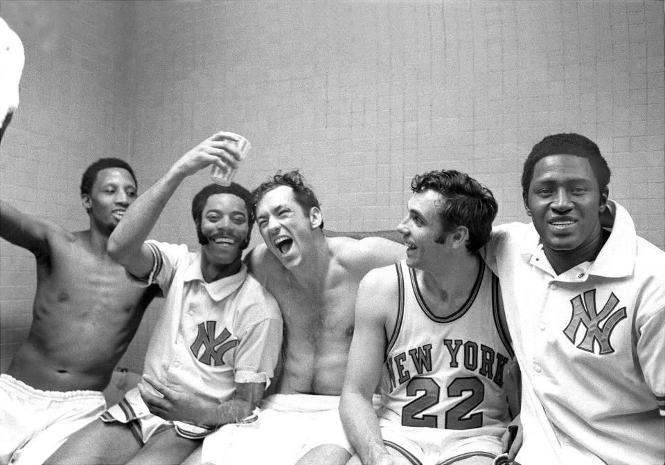 The New York Knicks' starting five — Dick Barnett, Walt Frasier, Bill Bradley, Dave DeBusschere and Willis Reed (left to right) — rejoice in the locker room after winning their fifth playoff game against the Milwaukee Bucks, by a lopsided score of 132-96, and with it their first Eastern Conference title since 1953. The Knicks eventually beat the Los Angeles Lakers in the Finals for their first-ever NBA championship.