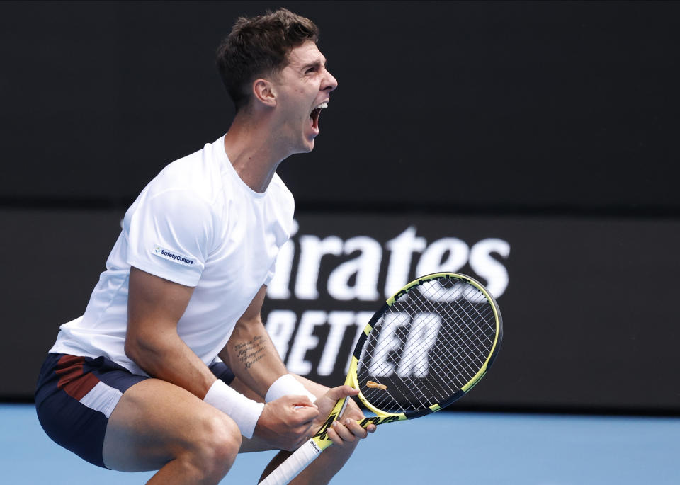 Australia's Thanasi Kokkinakis celebrates after winning the fourth set against Greece's Stefanos Tsitsipas during their second round match at the Australian Open tennis championship in Melbourne, Australia, Thursday, Feb. 11, 2021.(AP Photo/Rick Rycroft)