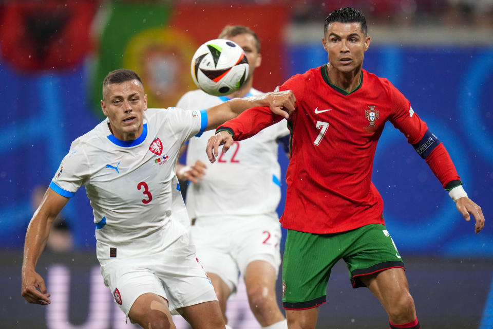 Portugal's Cristiano Ronaldo, right, duels for the ball with Czech Republic's Tomas Holes during a Group F match between Portugal and Czech Republic at the Euro 2024 soccer tournament in Leipzig, Germany, Tuesday, June 18, 2024. (AP Photo/Petr Josek)